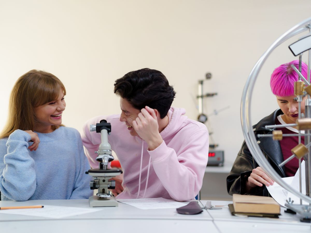 Students conducting a supervised experiment together in a science laboratory