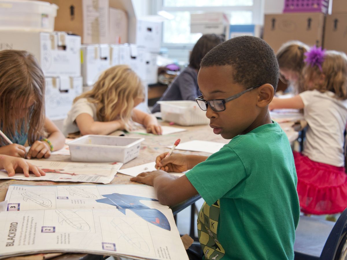Young children focused on educational activities in a primary classroom